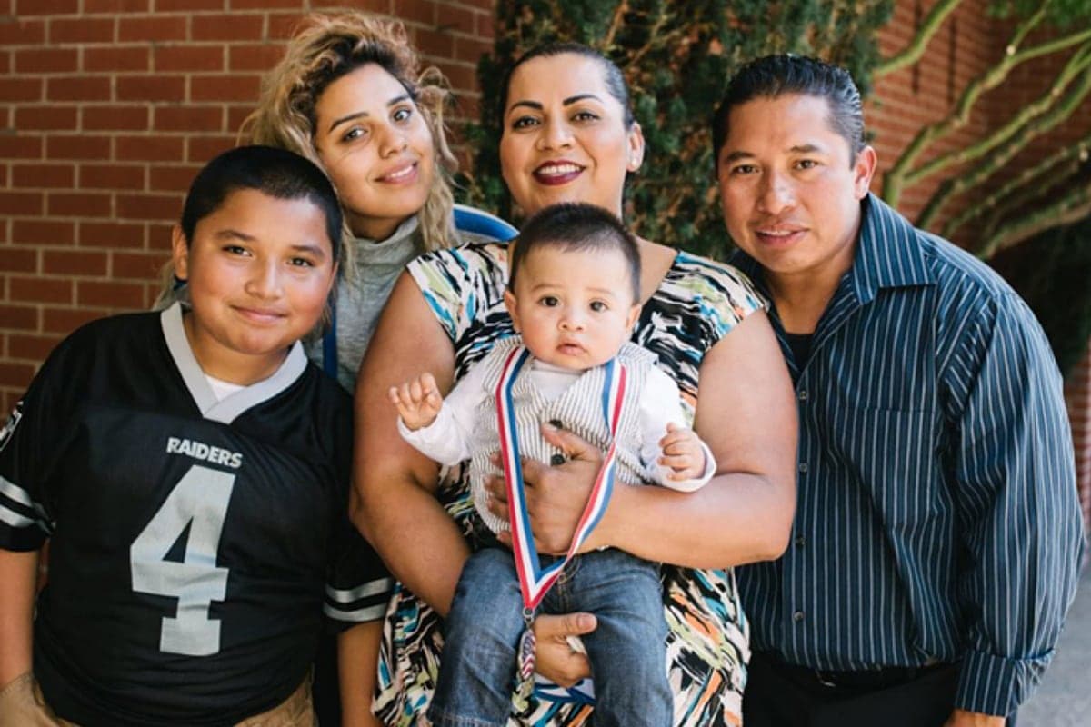 A Marin family photographed together outside a school building