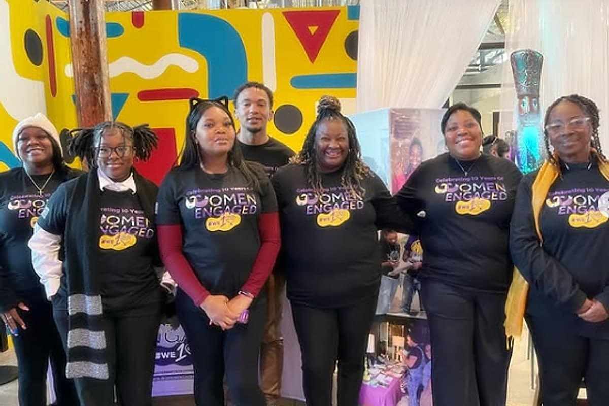 The Women Engaged team together in shirts marking ten years of the organisation